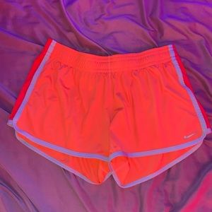 orange nike shorts, size medium.